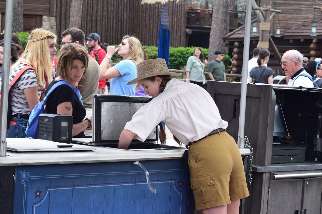 Cast member getting water from a cart Magic Kingdom.